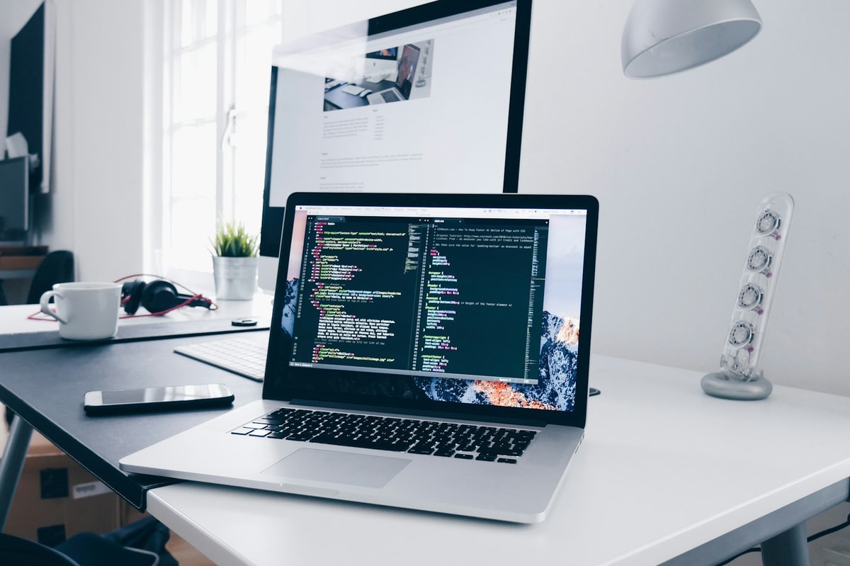 A laptop with code open on a desk